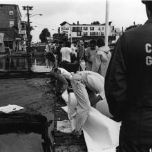 A Coast Guard officer oversees early attempts to clean up the June 1976 NEPCO-140 oil spill in the St. Lawrence River near downtown Alexandria Bay, NY.  