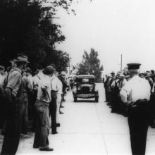 Crowd of striking farmers and local onlookers watching approaching non-striking farmer outside Sheffield Milk Plant, Heuvelton, NY, 1939